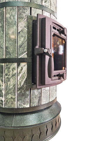 Close up of heavy duty cast iron door latch on green serpentine stone masonry heater