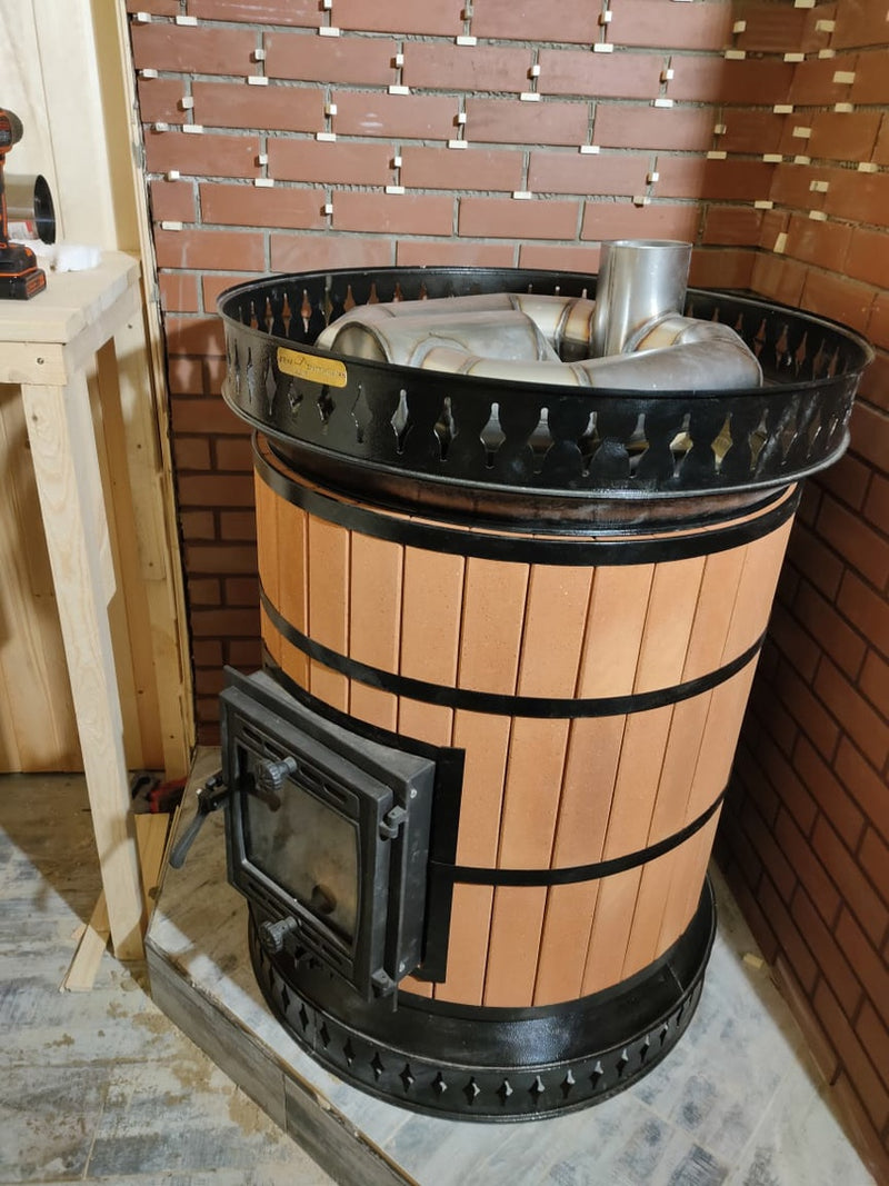 Internal view of the Volcano sauna stove assembly, showing the heavy-duty stainless steel smoke channels and heat exchanger designed for maximum thermal transfer.