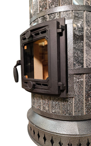 Close up of cast iron firebox door on Tundra Black amphibolite stone heater, included in DIY kit