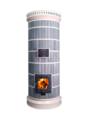 Front view of the Siberia model masonry heater kit in blue soapstone with white trim, featuring a glass firebox door with a wood fire burning.