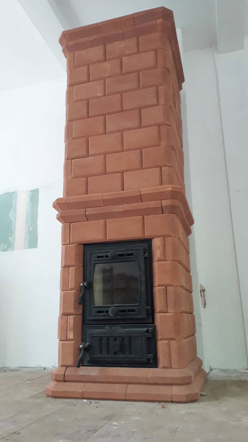 Vertical view of the rectangular Volga masonry heater, highlighting the traditional stepped cornice design and red brick texture.