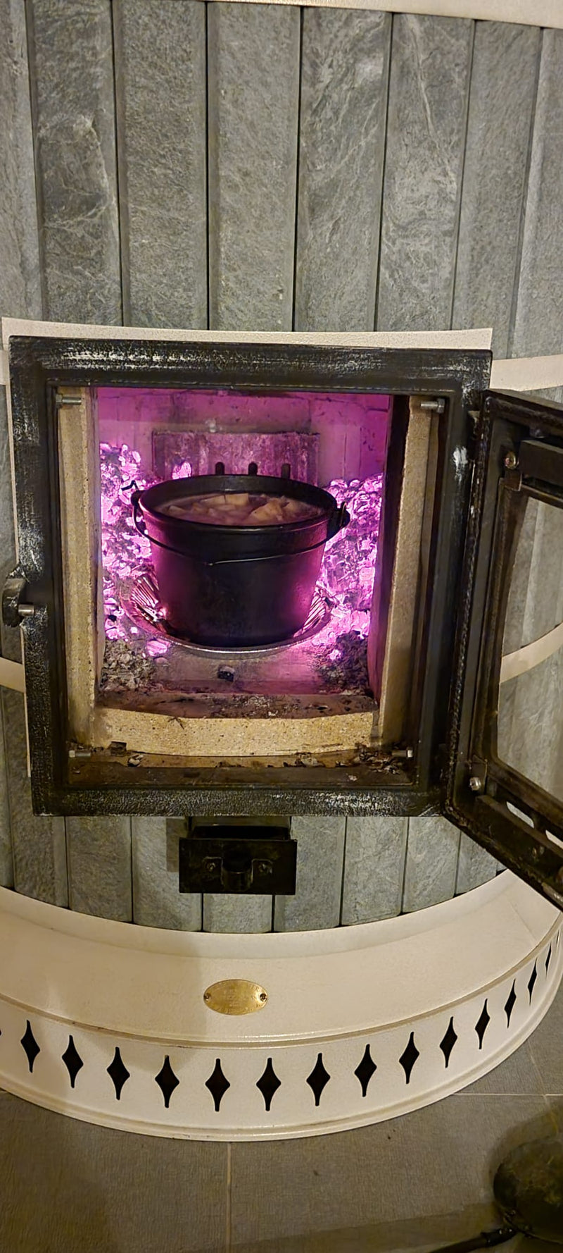 Using a soapstone Siberia  masonry heater as an off-grid oven to cook a large pot of stew during the winter.