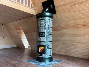 High-efficiency wood-burning Siberia  masonry heater with green serpentine stone finish installed in a modern timber-frame home.
