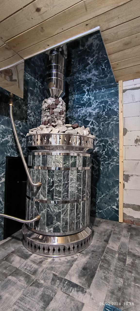 Luxury green serpentine sauna heater with polished chrome bands and matching stone wall panel