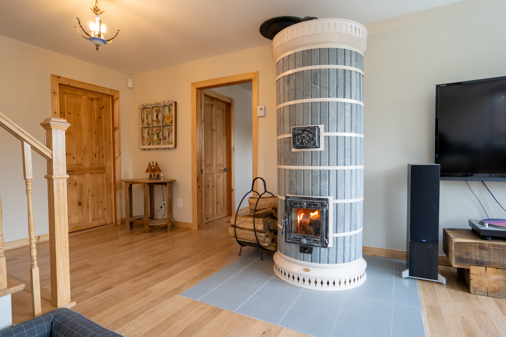 Full view of the Siberia soapstone masonry heater kit, installed in an off-grid cabin living room.