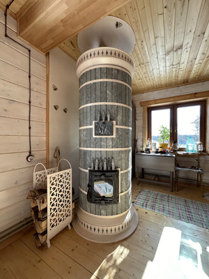 A Siberia DIY blue masonry heater kit, installed in an off-grid cabin in the woods.