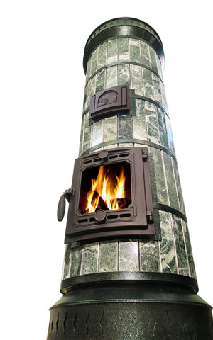 Low angle view of tall cylindrical green stone masonry heater with burning fire