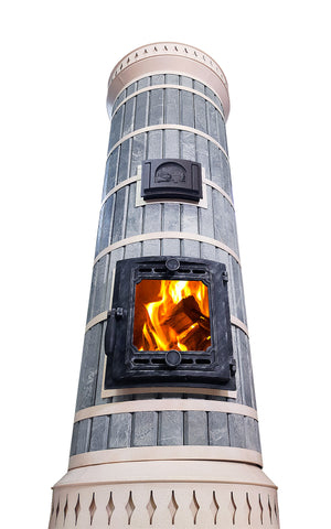 Low angle view of tall blue soapstone masonry heater, emphasizing height for heating cabin lofts