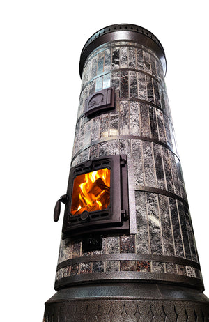 Low-angle view of the Siberia masonry heater, highlighting the tall cylindrical black amphibolite stone column and decorative black steel trim rings.