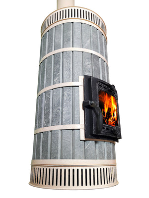 Whistler masonry heater kit in blue soapstone cladding with cream convection vents and cast iron firebox door